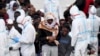 ITALY -- Migrants wait to disembark from Italian Coast Guard vessell "Diciotti" as it docks at the Sicilian port of Catania, southern Italy, Wednesday, June 13, 2018